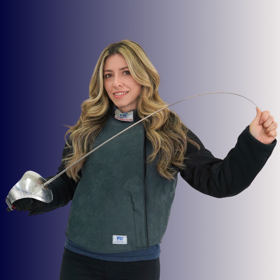 A woman with long blonde hair holding a fencing epee, wearing fencing gear, standing against a gradient background.